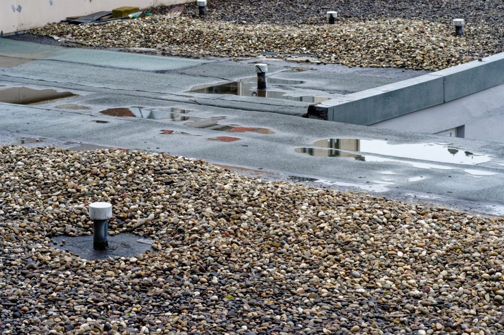 jng services Broken flat roof with macro with broken rubber for commercial roof repairs
