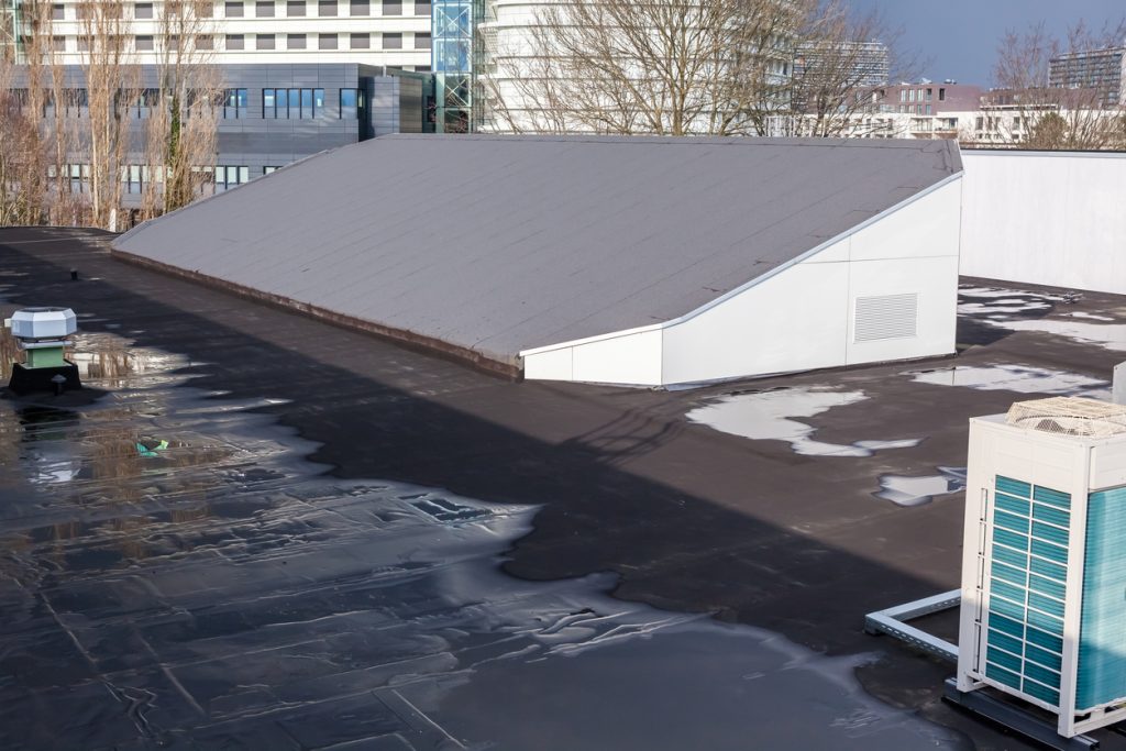 jng services commercial roof repairing damages on gym roof with water pooling and drainage issues 