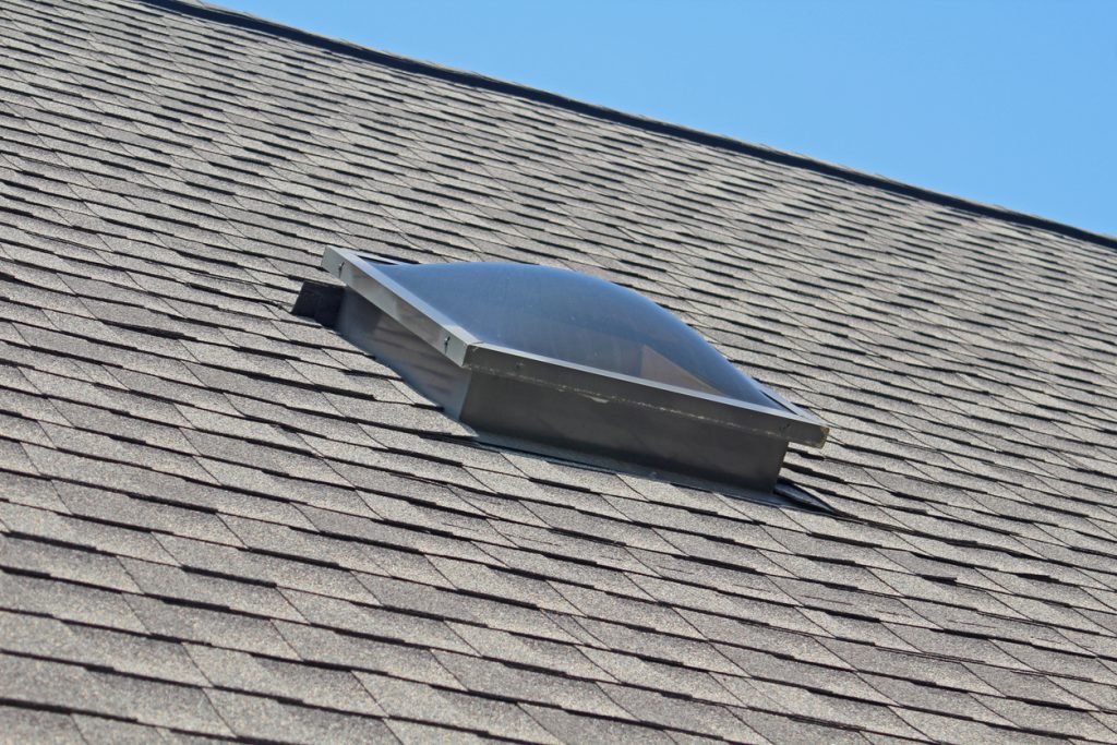 jng services tubular sky light on roof of house in day